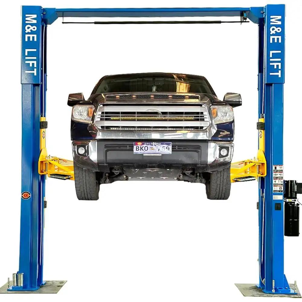 ME-LM110S blue two-post car lift with yellow arms lifting a pickup truck (front view).